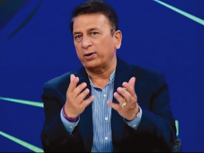 A focused Sunil Gavaskar sits in a cricket studio wearing a navy blazer and striped shirt, gesturing as he speaks about Indian cricket board reforms against a blue‑green background.
